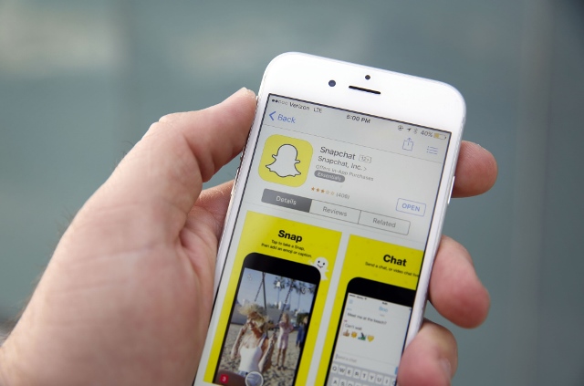 The Snapchat Inc. application is displayed in the App Store on an Apple Inc. iPhone 6 in this arranged photograph taken in the Venice Beach neighborhood of Los Angeles, California, U.S., on Wednesday, March 2, 2016. People using the application for disappearing photos view 8 billion videos a day, the same number that Facebook reports, the CEO Evan Spiegel told an audience at the Morgan Stanley technology conference Photographer: Patrick T. Fallon/Bloomberg